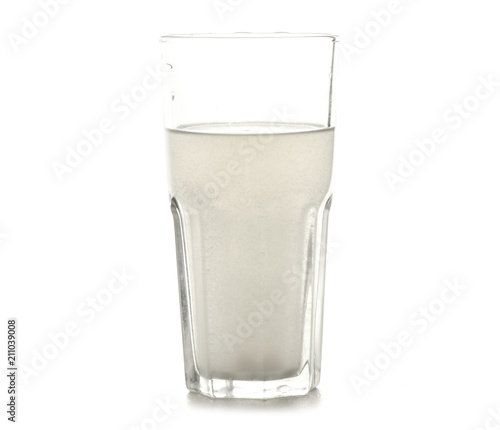 Fotografi A glass of salt of soda for rinsing teeth on a white background isolation
