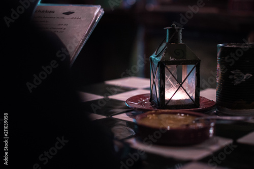 candle-lit lantern on a checkered 