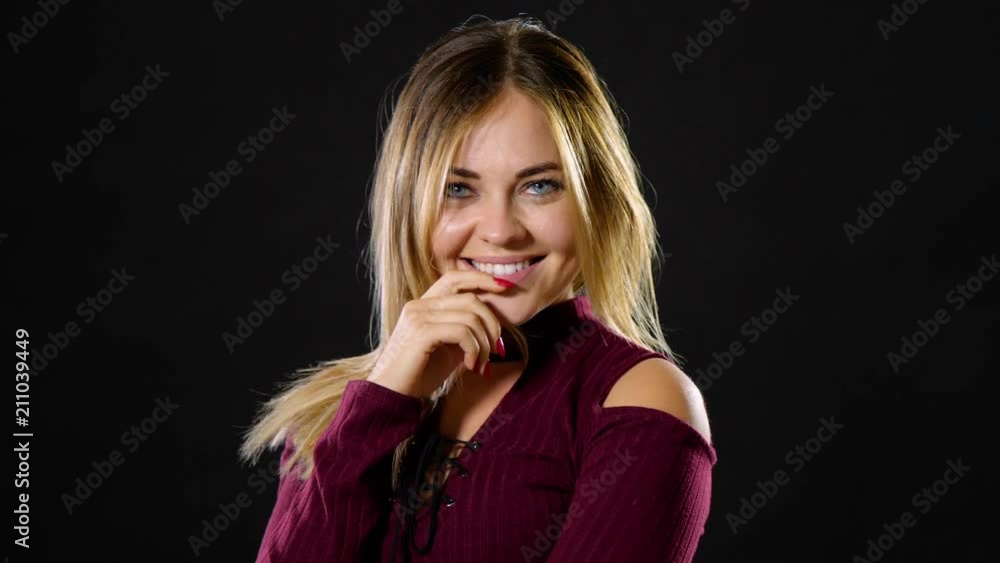 Pretty blond woman smiling and acting playful. Pretty blond woman smiling and acting playful.