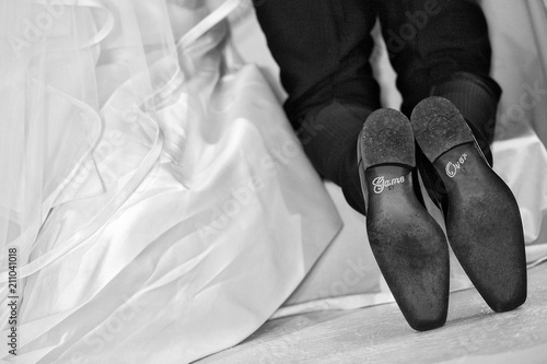 dettaglio di scarpe da uomo di sposo in ginocchio all'altare con la scritta 