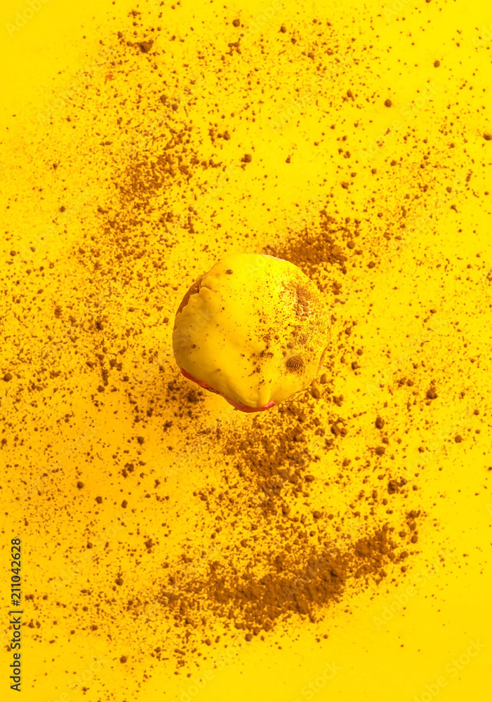 Obraz premium colored glazed donut falling or flying in motion against yellow pastel background with chocolate texture. Concept of food, colorful breakfast. Macro concept. closeup, copy space,vertical shot