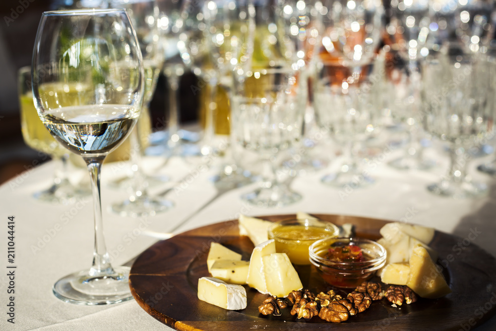 assortment of delicious cheese, grapes and honey on dinner table