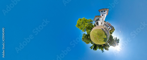 Foto Green little planet with trees, soft blue sky and building