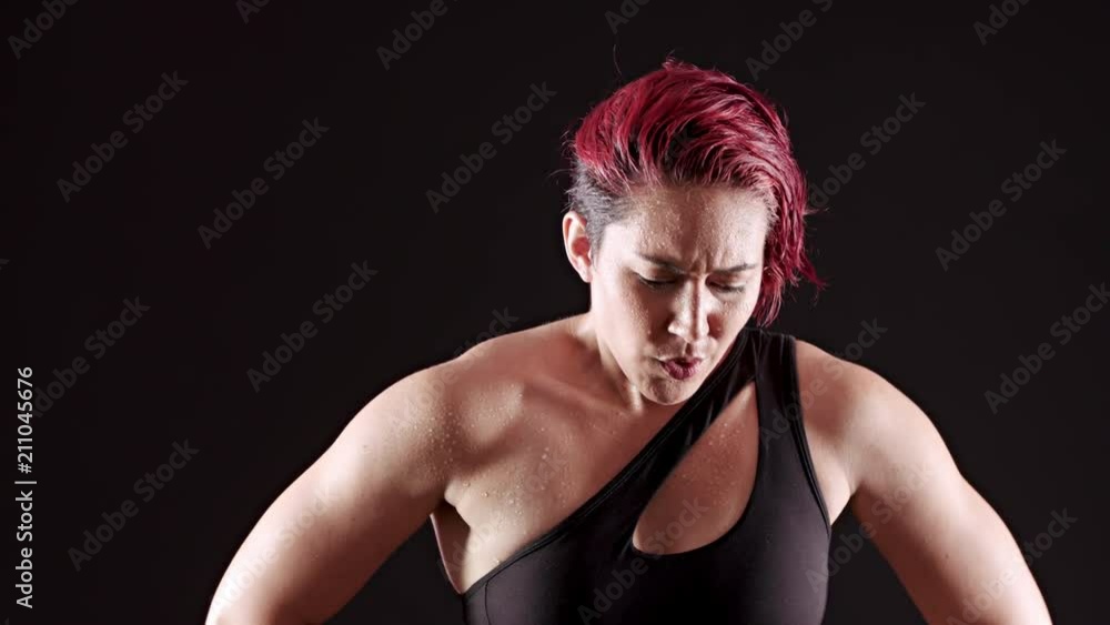 Athletic woman working out with a battle rope. Athletic woman working out with a battle rope.