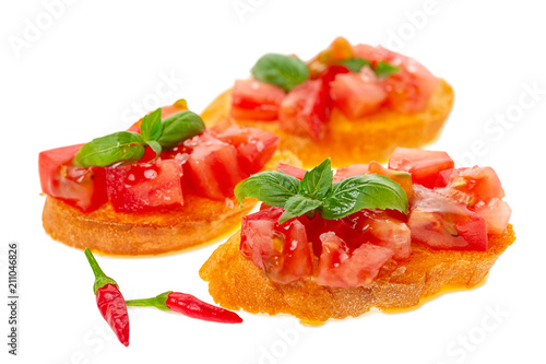 savory tasty chopped tomato on toasted baguette garnished with basil and peppers  Italian appetizers bruschetta  isolated on white background