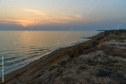 Sunset over the sea on wild beach of Persian gulf coast. Iran photo