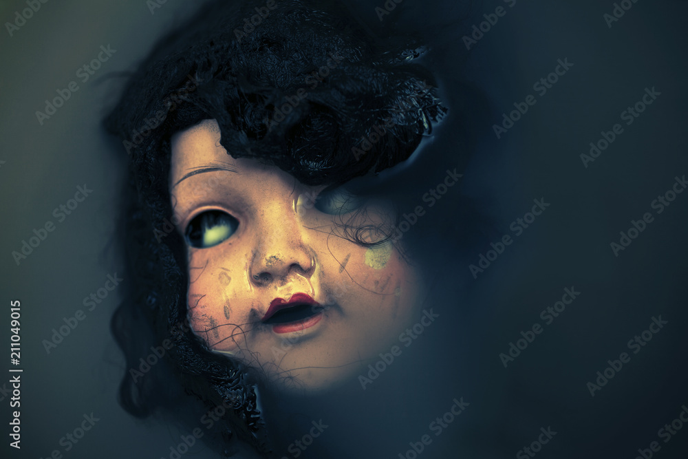 Creepy doll face in dark dirty water Creepy doll face in dark dirty water