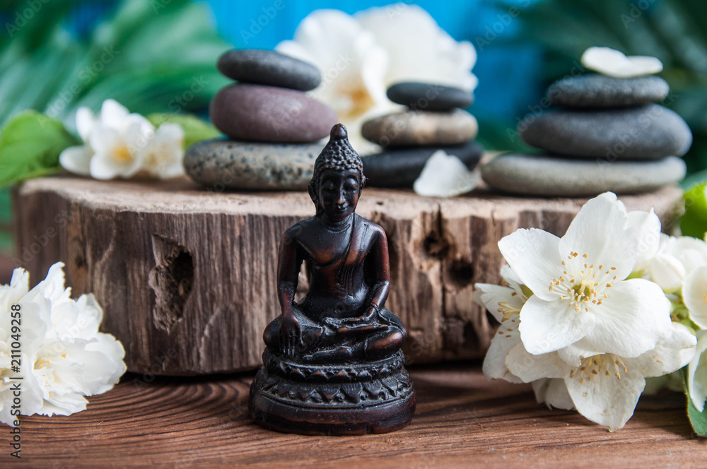 Zen: Pyramids of gray zen stones with beautiful fresh white flowers and Buddha statue. Concept of harmony, balance and meditation, spa, massage, relax Zen: Pyramids of gray zen stones with beautiful fresh white flowers and Buddha statue. Concept of harmony, balance and meditation, spa, massage, relax