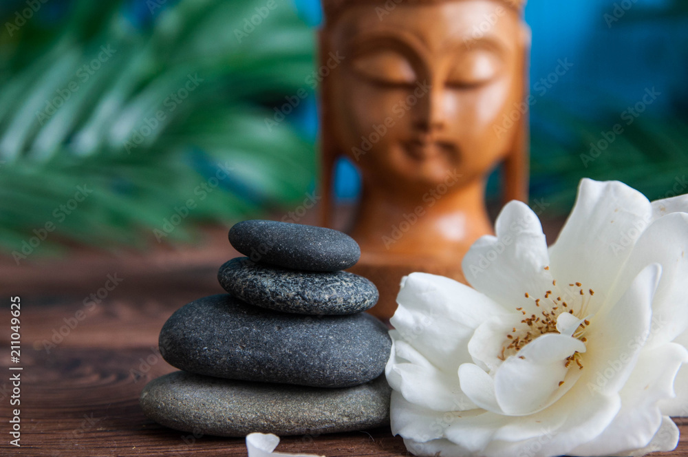 Zen Pyramids of gray zen stones with beautiful fresh white flowers and