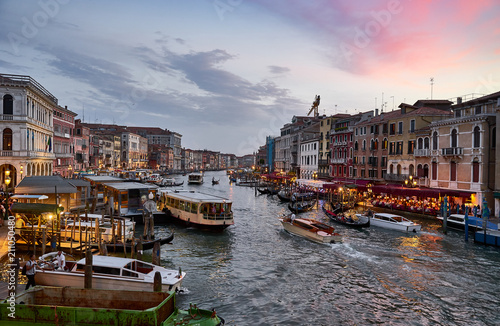 Canal Grande with boats and lights in Venice at Sunset. Next to famous Rialto Bridge and the Street "Riva del fin" - Italy © marako85