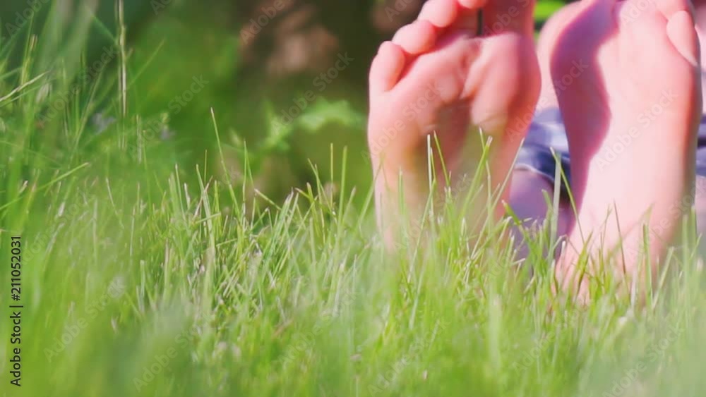 children's bare feet on green grass. close-up children's bare feet on green grass. close-up
