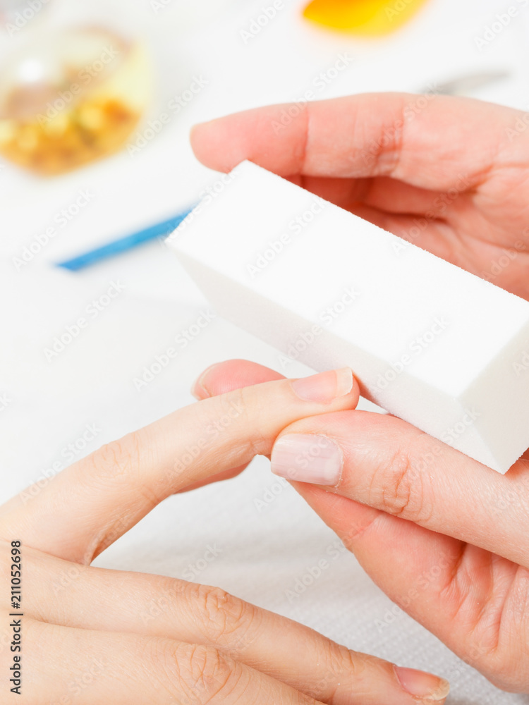 Preparing nails before manicure, beautician file nails Preparing nails before manicure, beautician file nails