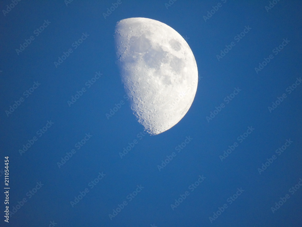 An amazing caption of the half moon over the city of Genova by day with a great blue sky in background An amazing caption of the half moon over the city of Genova by day with a great blue sky in background