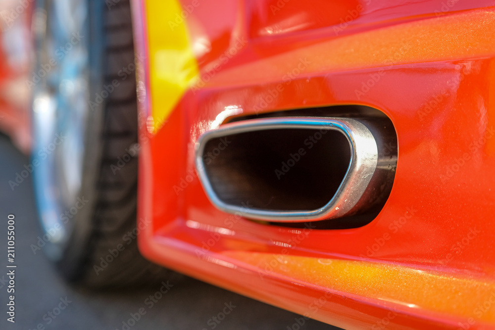 Fototapeta premium Close up of tuning red car exhaust pipe.