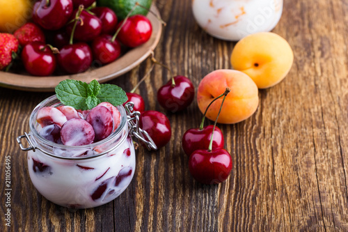 Healthy breakfast with sweet cherry yogurt and fresh summer fruits