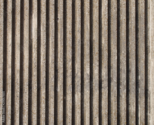 textured cast concrete wall with vertical lines and stripes