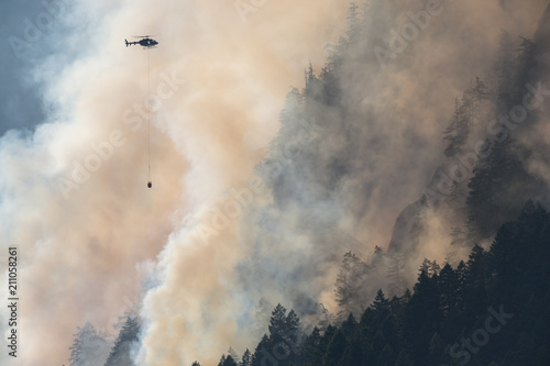 Mountain wood fire with Fire department helicopter