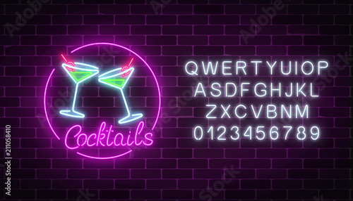 Neon cocktails bar sign with alphabet. Glowing gas advertising with glasses of alcohol shake.