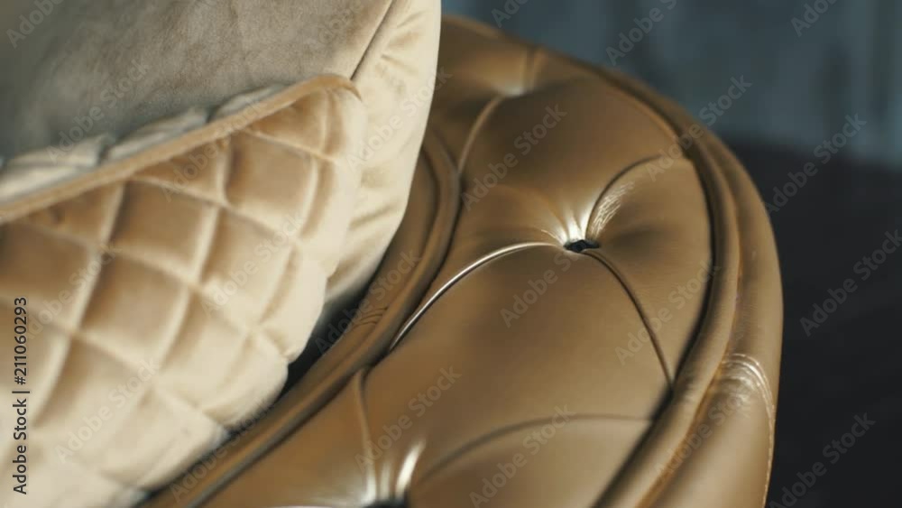 Close up leather pattern of a gold luxury sofa in the living room for background texture Close up leather pattern of a gold luxury sofa in the living room for background texture