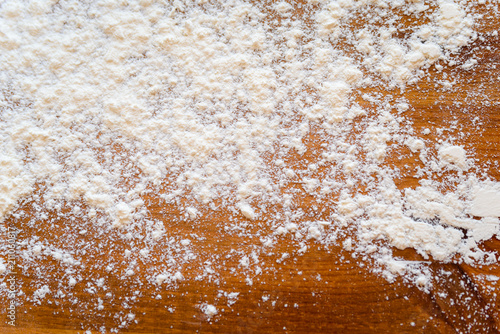 Top side view on white flour on rustic wooden table background, closeup of healthy cooking copyspace surface at home, restaurant, fabric plant © gorosi