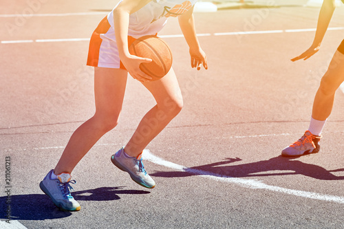 Girls teenagers basketball player play and train on the basketball.
