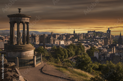 Beautiful sunset view from Calton Hill in Edinburgh, Scotland with monument and historical buildings in the city © Kateina