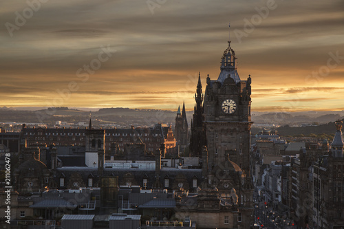 Beautiful sunset photo of Edinburgh city with clocktower and historical buildings