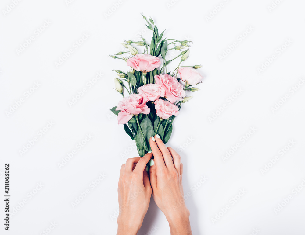 Florist making a bouquet of beautiful blooming eustomas