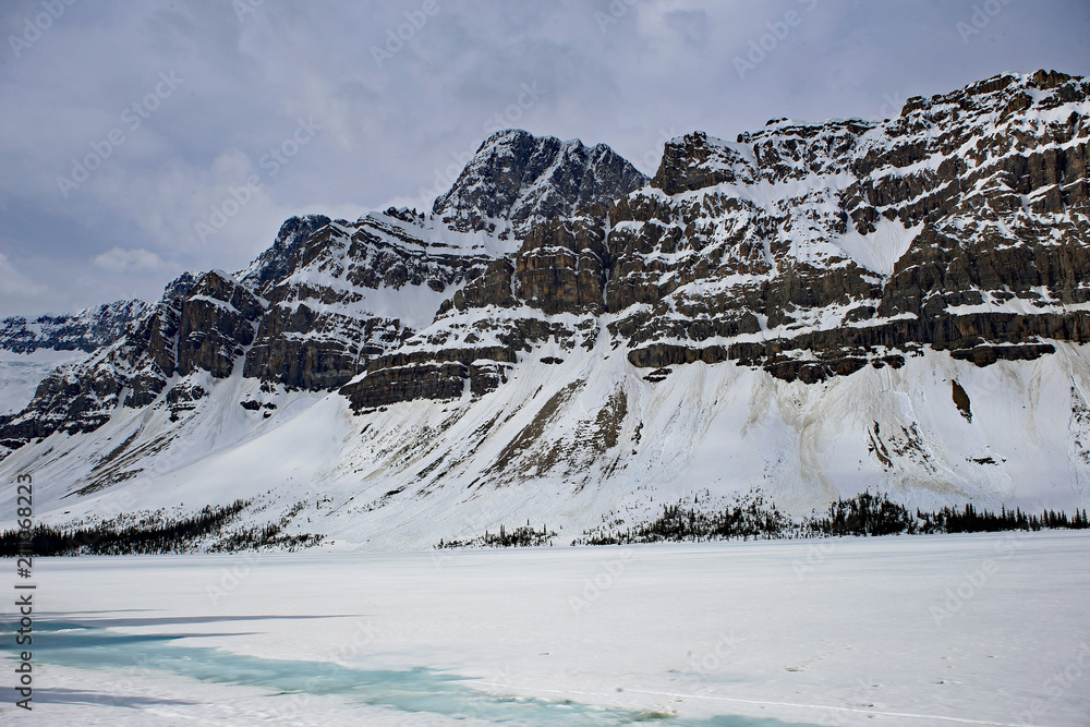 Breathtaking view on winter Bow lake in Canadian Rockies with blue sky
