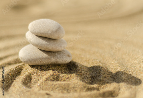 zen meditation stone in sand  concept for purity harmony and spirituality  spa wellness and yoga background