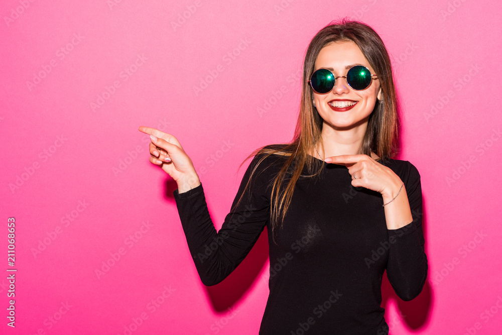 Excited screaming pointed side beautiful woman standing isolated over pink background. Excited screaming pointed side beautiful woman standing isolated over pink background.
