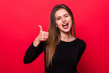 Thumbs up like woman smiling happy with natural smile on red background
