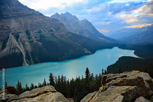 Peyto Lake view from Bow Summit along the Columbia Icefields Parkway in Banff National Park, Canada, turquoise glacier water, mountains and clouds in the background © Jitka