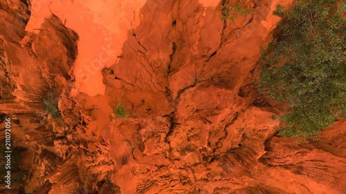 AERIAL. Overhead sliding drone shot of Red Canyon rocks in Mui Ne, Vietnam. Abstract orange background for text or title