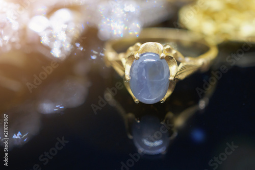 Vintage gold Jewelry blue sapphire rings with reflection on black background