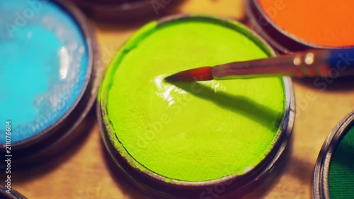 jars of make-up of different colors close-up. photo