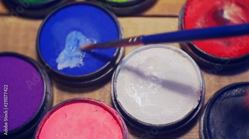 jars of make-up of different colors close-up. photo