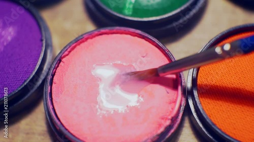 jars of make-up of different colors close-up. photo