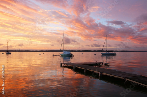 Beautiful marine after sunset background.Amazing summer evening landscape with group of drifting yachts on a lake Mendota during spectacular sunset. Bright sky reflects in the lake water. Madison, WI. photo