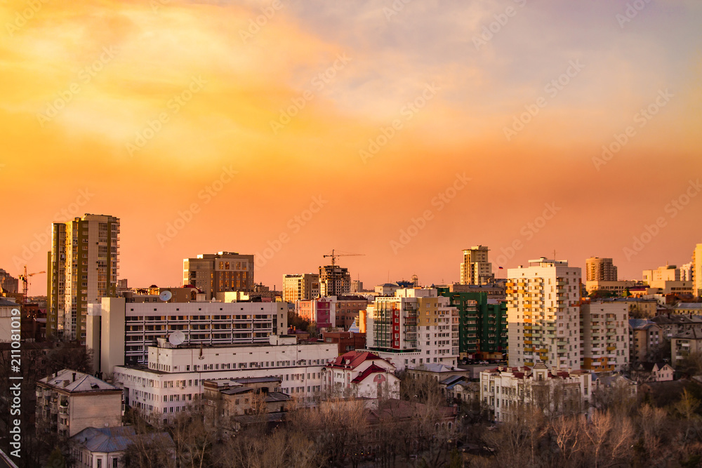 city view from above during the sunset with the pink and yellow sky on the background