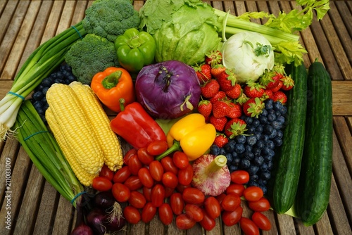 Fresh organic fruits and vegetables on a wooden table       