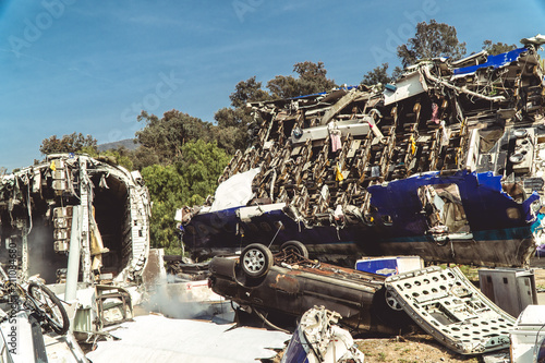 Airplane fuselage and overturned car from crash
