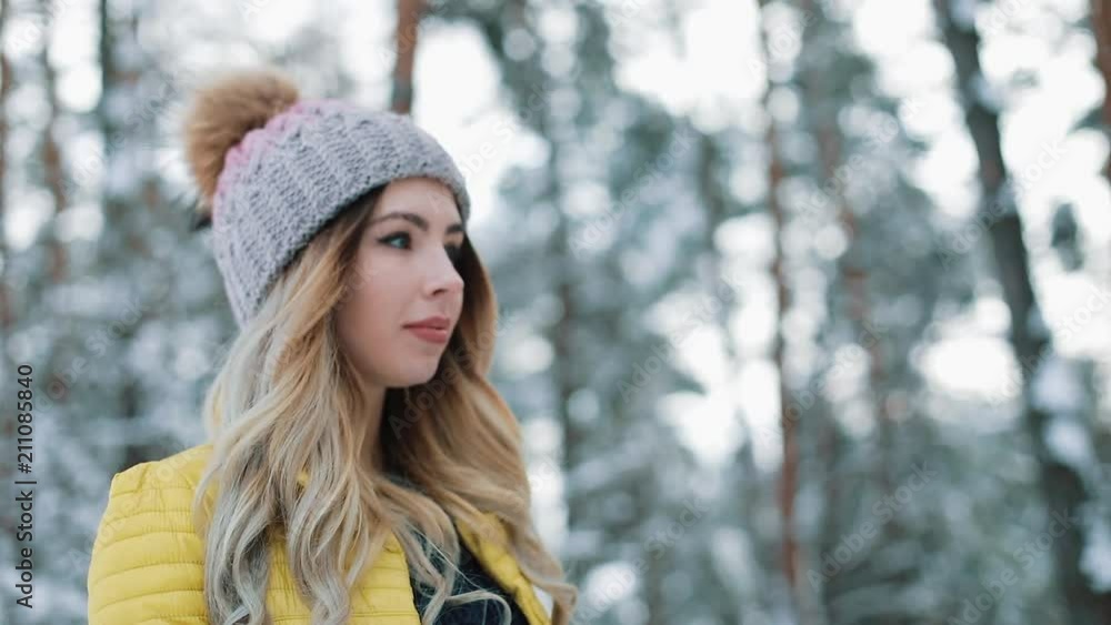 Pretty young woman walks around a winter forest Pretty young woman walks around a winter forest