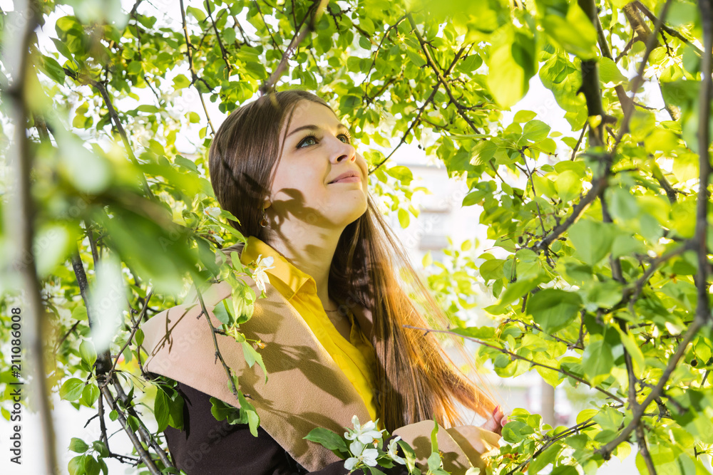 Beautiful young woman near apple tree Beautiful young woman near apple tree