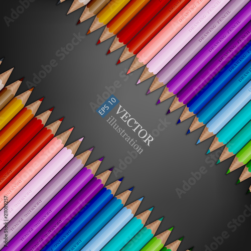 Rows of rainbow colored pencils on dark grey background. photo