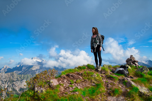 At the top of the mountains. A lonely girl looks at the view