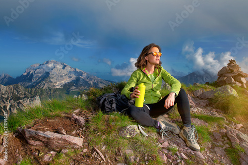 A girl rests after climbing the top of a mountain