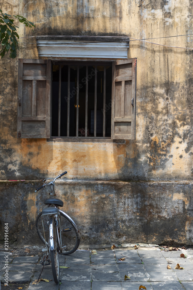 Bicycle parked in front of an abandoned building Bicycle parked in front of an abandoned building