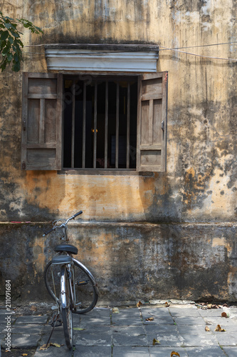 Bicycle parked in front of an abandoned building