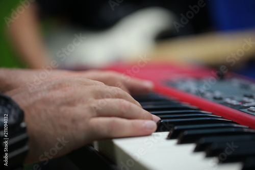 hands of a man playing piano